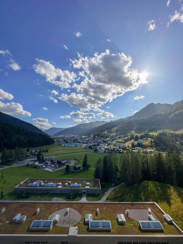 an aerial view of a resort with mountains in the background at AlpenGold Hotel Davos in Davos