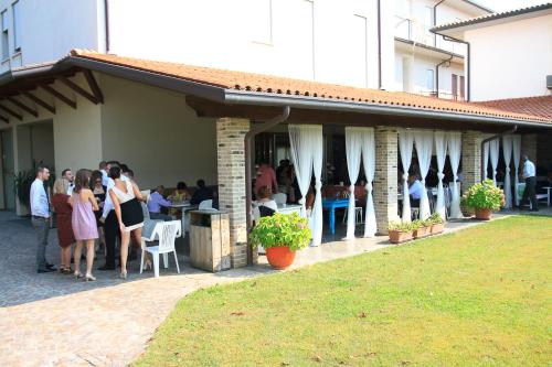 a group of people standing outside of a restaurant at Park Hotel Italia in Tezze sul Brenta