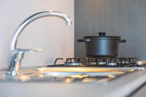 a pot on top of a stove in a kitchen at La Casa Nelle Aie - Appartamento Nebbiolo - Free WiFi e AC in La Morra