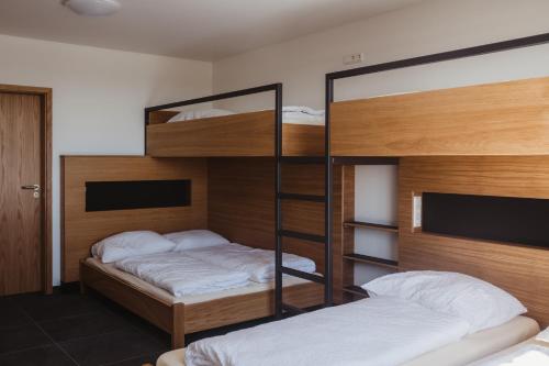 a bedroom with two bunk beds and a television at Robbesscheier in Munshausen