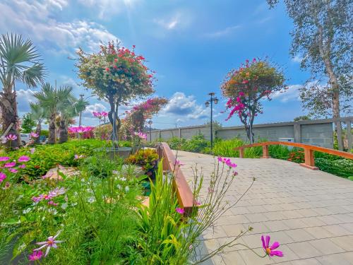a garden with flowers on a walkway at Greenlife Village Phú Quốc in Phu Quoc