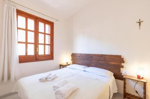 a bedroom with a large white bed with towels on it at Casa Vacanze Maria in San Vito lo Capo