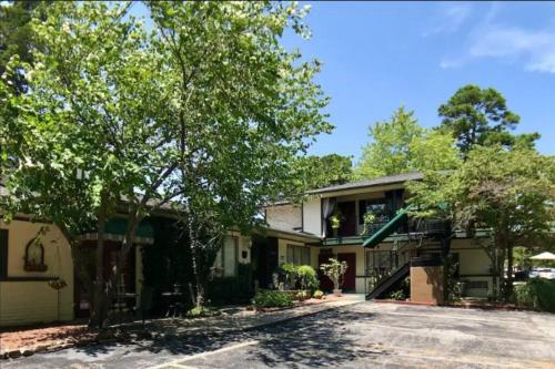 a house with a driveway in front of it at Deer Hollow Cottage at Tradewinds in Eureka Springs