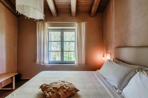 a bedroom with a large bed with a window at Dandelion Como Suites & Park in Villa Guardia