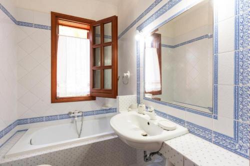 a bathroom with a sink and a bath tub and a sink at Casa Vacanze Maria in San Vito lo Capo