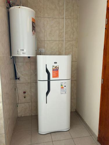 a refrigerator and a water heater in a room at Apartamentos El Viñedo 8 in General Alvear