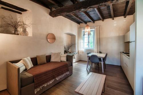 a living room with a couch and a table at Dandelion Como Suites & Park in Villa Guardia