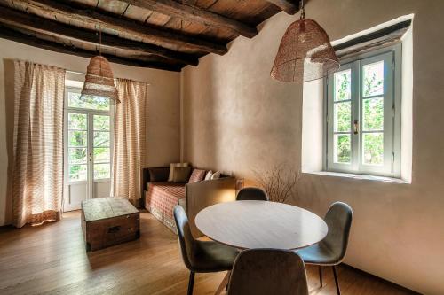 a living room with a table and chairs at Dandelion Como Suites & Park in Villa Guardia