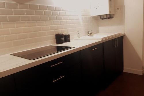 une cuisine avec un évier et un plan de travail dans l'établissement In the heart of Sarlat- Charming & Authentic House, à Sarlat-la-Canéda