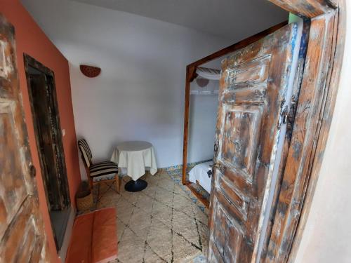 an open door in a room with a table at Dar Halima in Essaouira