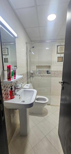 a bathroom with a sink and a toilet at Luxury Private Room in Sharjah in Sharjah