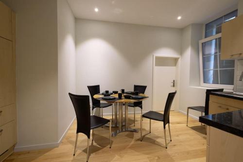 a kitchen and dining room with a table and chairs at Visp Gem for 6 in Visp