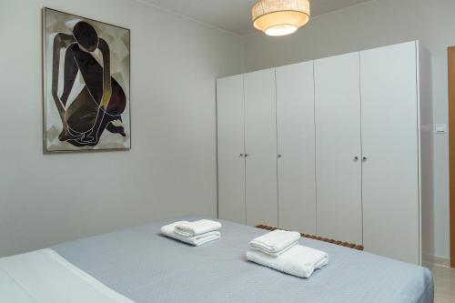 a bedroom with a bed with towels on it at Zoe's Place - 2 BD Beachfront Apartment in Kissamos