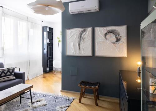 a living room with three pictures on the wall at cozinesT eco apartment in Zagreb