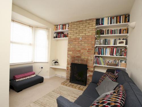 a living room with a couch and a fireplace at Sunny Victorian 2BR Townhouse Oxford - Pass the Keys in Oxford