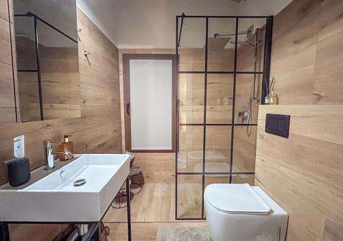 a bathroom with a sink and a toilet and a shower at Casale Gambini in Quattro Castella