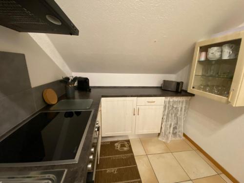 a small kitchen with a black counter top at Haus Stegmeir in Hohenweiler