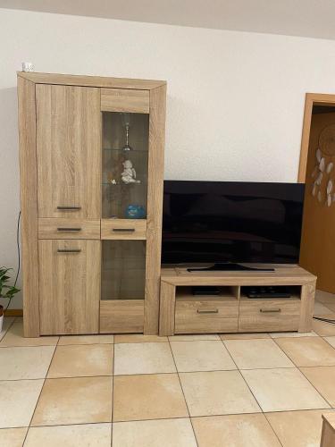 a wooden entertainment center with a flat screen tv at Haus Stegmeir in Hohenweiler