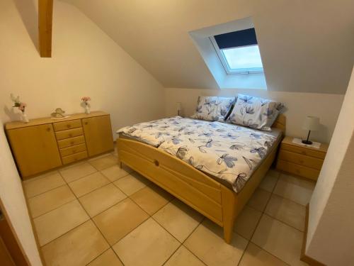 a small bedroom with a bed and a window at Haus Stegmeir in Hohenweiler