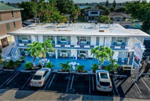 an aerial view of a hotel with two cars parked in a parking lot at Sunset Beach Suites at Madeira Beach! Steps to Beach & Restaurants! - Suite 6 in St Pete Beach