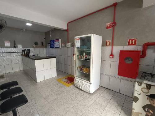 a kitchen with an open refrigerator in a room at Pousada Santo Amaro in Juazeiro do Norte