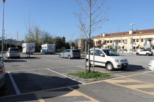 a parking lot with several cars parked in it at Civico 26 in Treviso