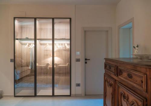 a bedroom with a glass door leading to a bed at Casale Gambini in Quattro Castella