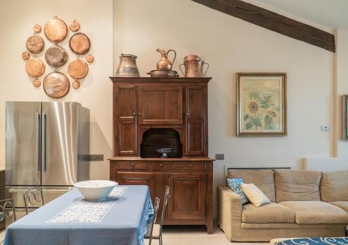 a living room with a couch and a refrigerator at Casale Gambini in Quattro Castella