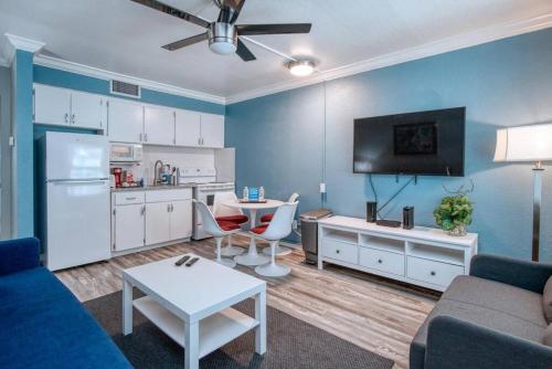 a living room with a couch and a table and a kitchen at Sunset Beach Suites at Madeira Beach! Steps to Beach & Restaurants! - Suite 6 in St Pete Beach