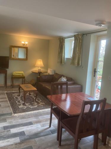 a living room with a couch and a table at The Coach House Annex in Tilston