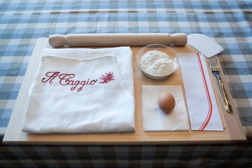 a wooden tray with a bag of flour and an egg at Agriturismo Il Caggio in Sovicille