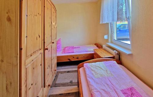 a small room with two beds and a window at 1 Bedroom Cozy Home In Blankensee Ot Wanzka 
