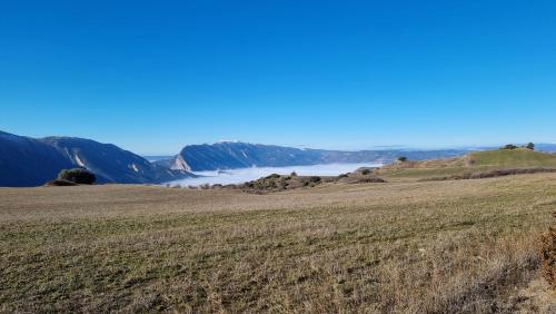 a field with a view of a river and mountains at Lo Cel De Tolo in Toló