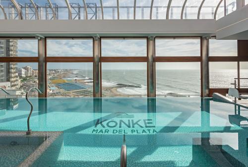 a swimming pool on top of a building with a view of the ocean at HOTEL KONKE MAR DEL PLATA in Mar del Plata