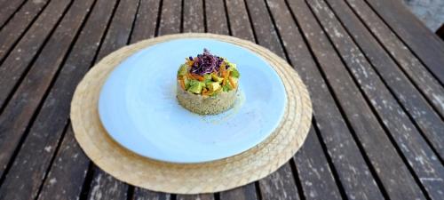 a plate of food on a wooden table at Lo Cel De Tolo in Toló
