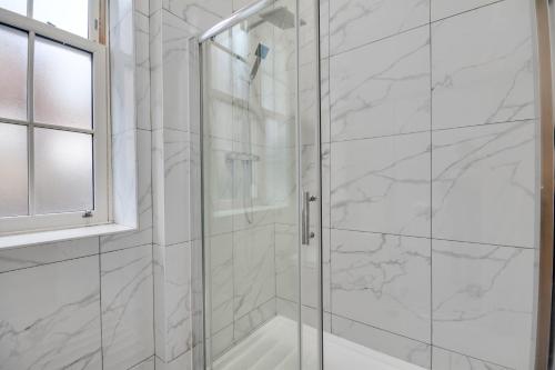 a bathroom with a shower with a glass door at Lovely 1-Bed Apartment in Wigan in Wigan