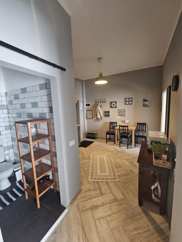 a living room with a fireplace and a dining room at ZIG ZAG apartment 4- Old Town in Constanţa