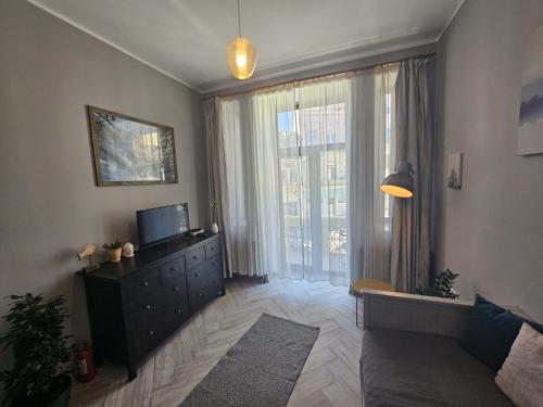 a living room with a television and a large window at ZIG ZAG apartment 4- Old Town in Constanţa