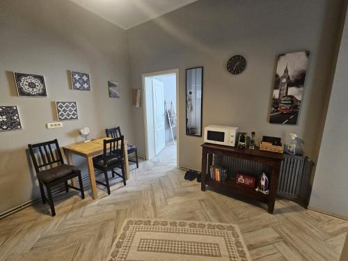 a living room with a table and chairs and a microwave at ZIG ZAG apartment 4- Old Town in Constanţa