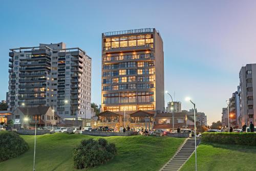 a tall building with lights on in a city at HOTEL KONKE MAR DEL PLATA in Mar del Plata