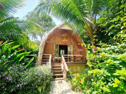 a small house with a staircase leading to it at Bamboo Eco Village in Can Tho