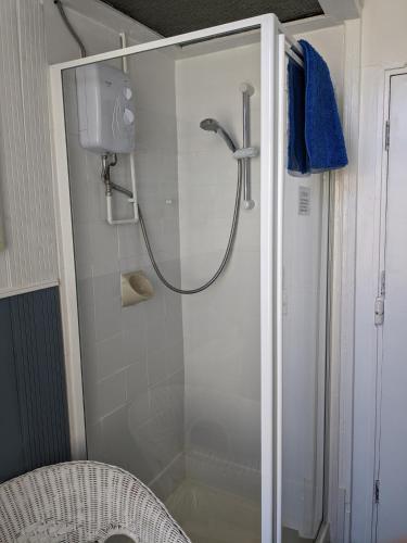a shower with a glass door in a bathroom at Willin House Hotel in Blackpool