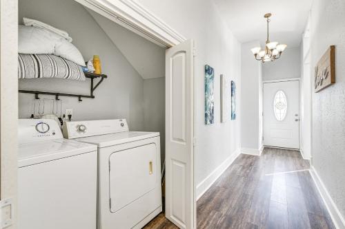 a laundry room with a washer and dryer and a hallway at Pet-Friendly Galveston Getaway about 1 Mi to Beach! in Galveston