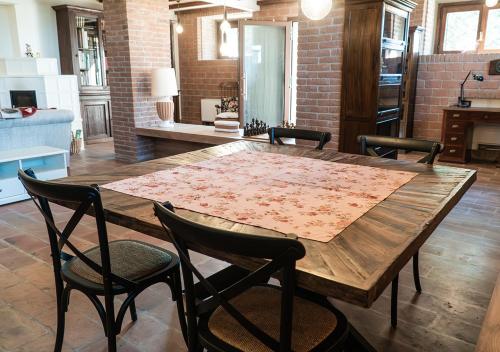 a wooden table and chairs in a living room at Casale Gambini in Quattro Castella