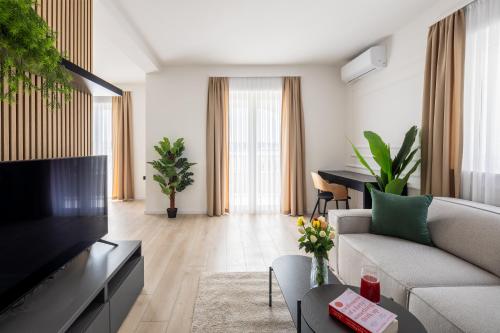 a living room with a couch and a tv at VIPo Seget Apartments in Trogir