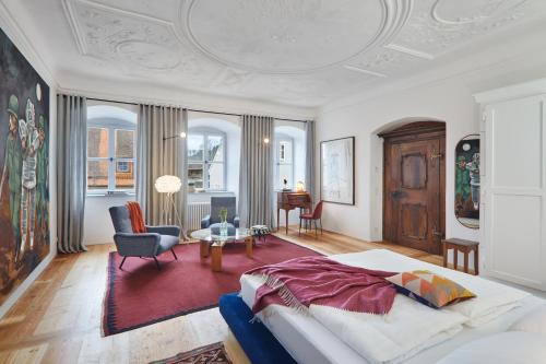 a bedroom with a bed and a living room at Engelwirt Hotel & Apartments in Berching