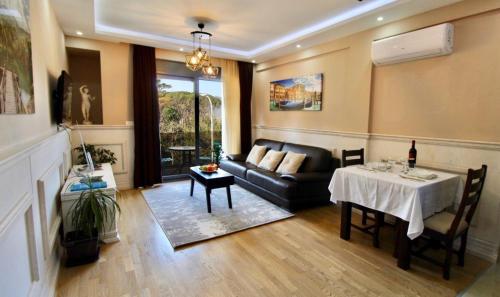 a living room with a couch and a table at Central Park Apartment in Tivat