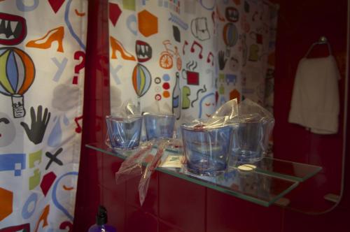 a shelf with four plastic containers on it at Hotel Tejuma in Puerto de la Cruz