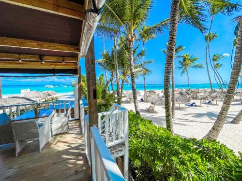 a view of the beach from the balcony of a resort at BAVARO Los Corales SOL Caribe STUDIOS Rooms DELUXE WiFi Parking BEACH CLUB & SPA in Punta Cana