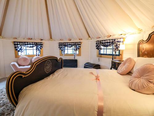 a bedroom with a large bed with pillows on it at Applejacks Orchard in Holywell